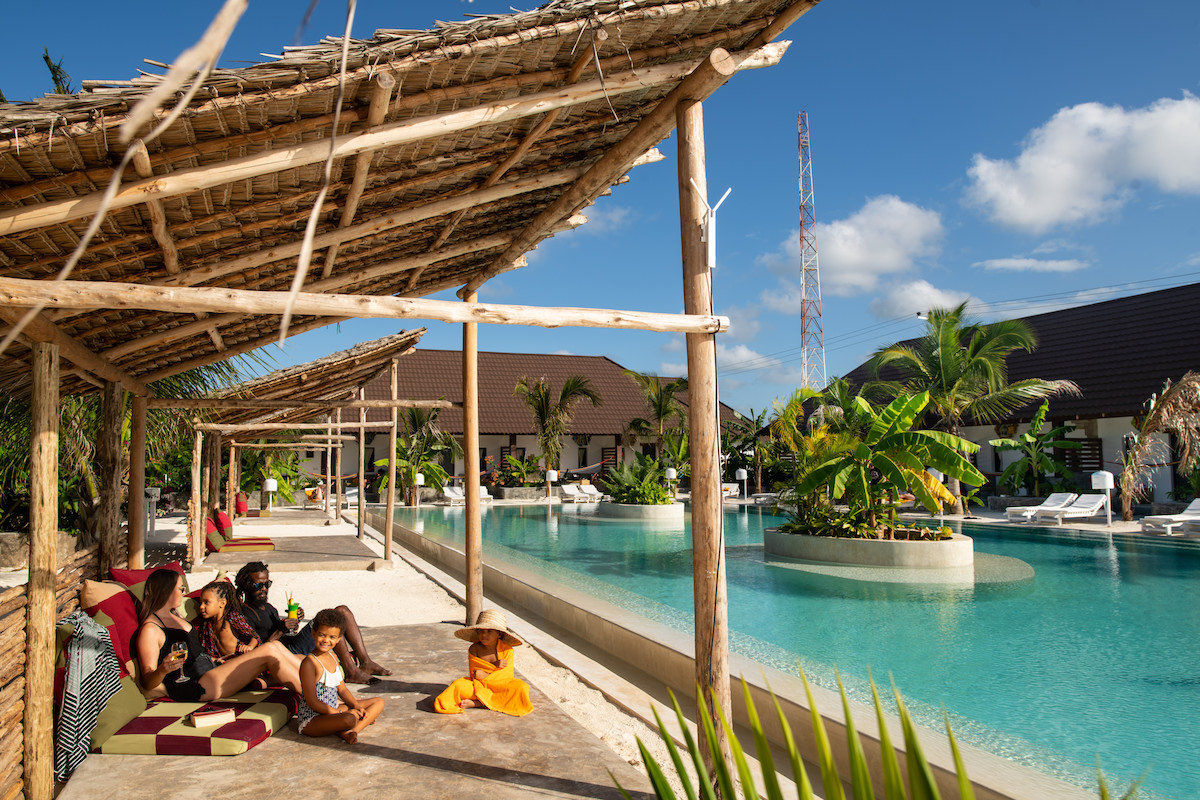 Family sat around back pool at Fun Beach Hotel Zanzibar
