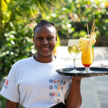 Staff member carrying tropical juice at Fun Beach Hotel Zanzibar
