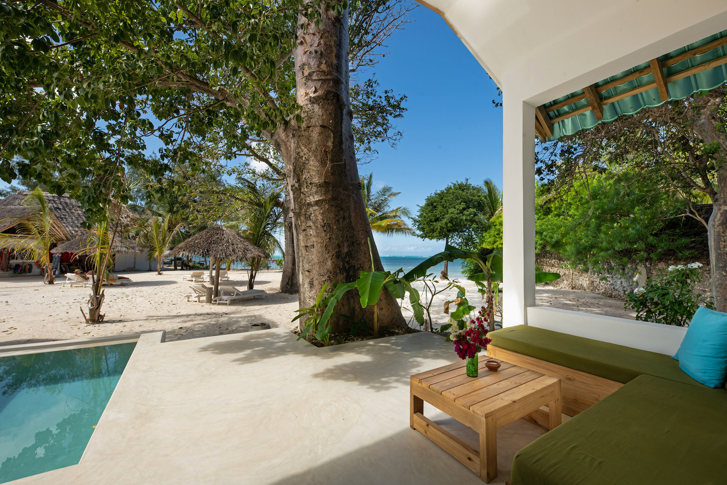 Veranda with couch pool and sea view at Suite Room at Fun Beach Hotel Zanzibar