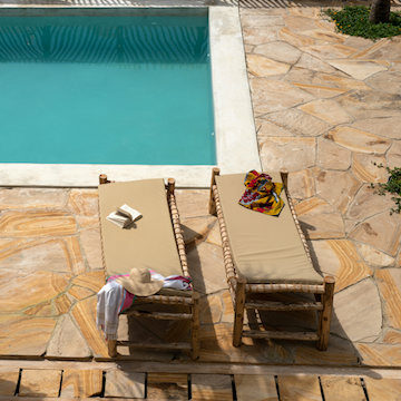 Our Zanzibar Nyumbani Residence sun loungers around swimming pool