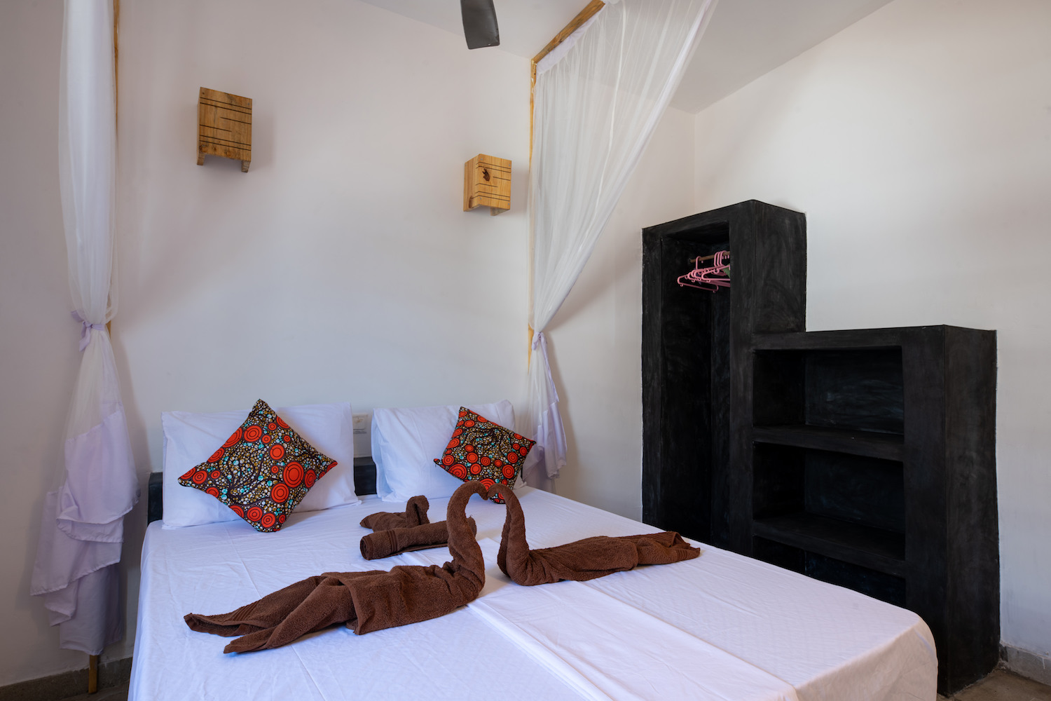 Our Zanzibar Group Nyumbani Residence double bed with mosquito net and wardrobe one bedroom apartment