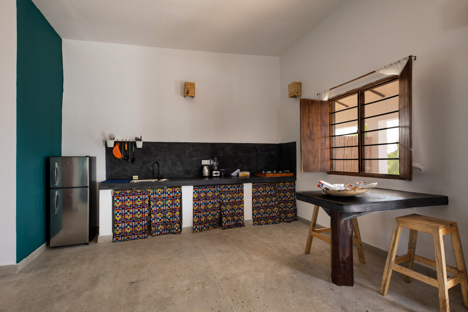 Our Zanzibar Group Nyumbani Residence kitchen with table and stools one bedroom apartment