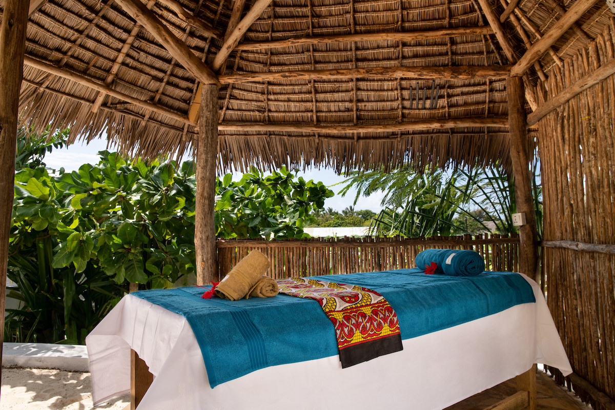 Our Zanzibar Group Nyumbani Residence massage bed under makuti structure
