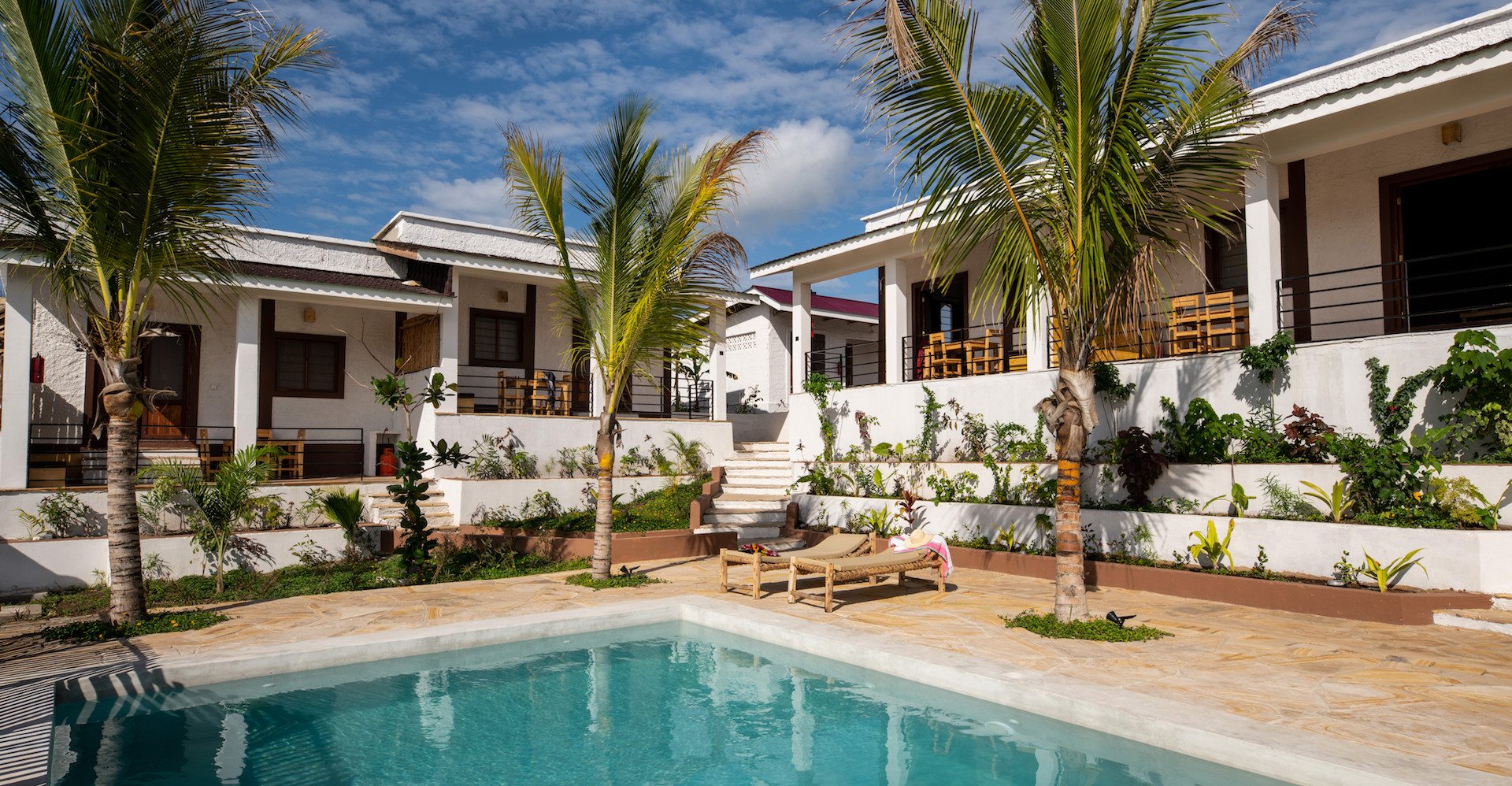 Our Zanzibar Group Nyumbani Residence pool palm trees and apartments