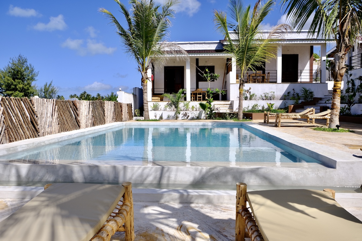 Our Zanzibar Group Nyumbani Residence swimming pool with palm trees